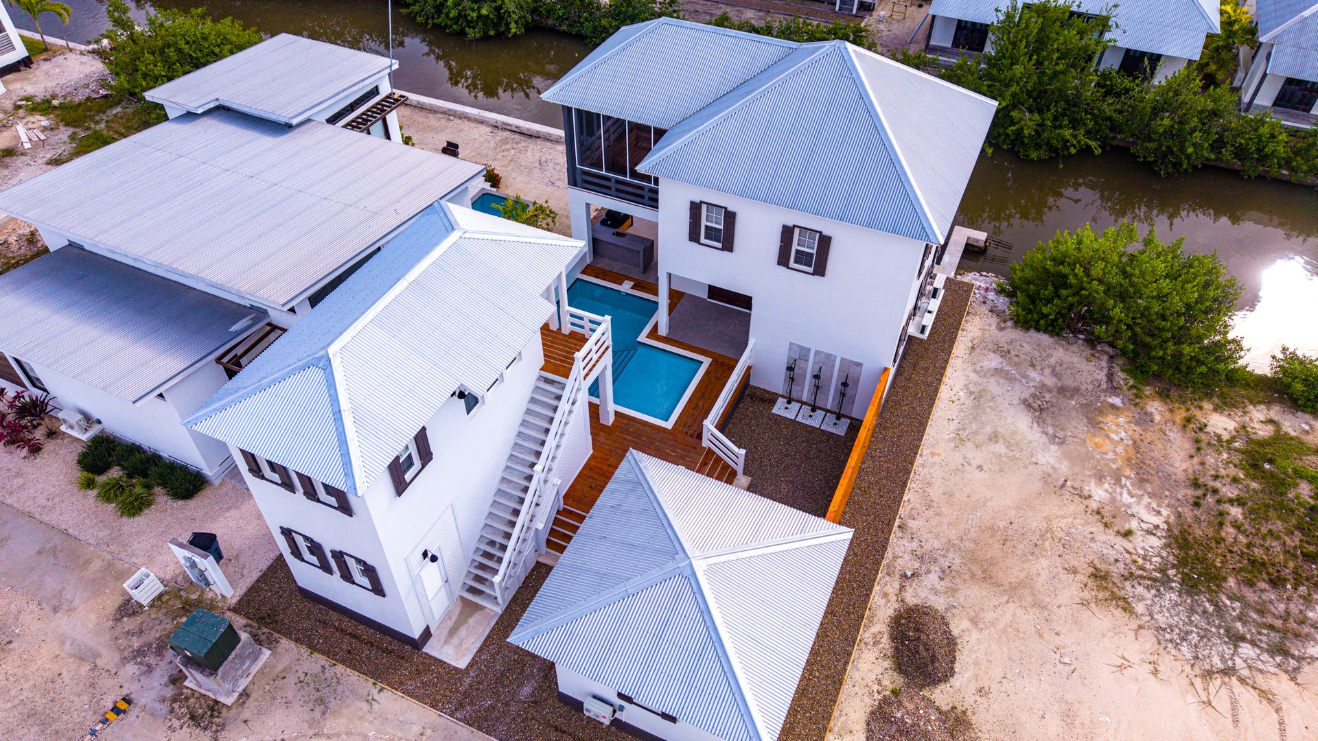 Aerial view of the Chasing Sunsets compound and pool in Mahogany Bay, Belize